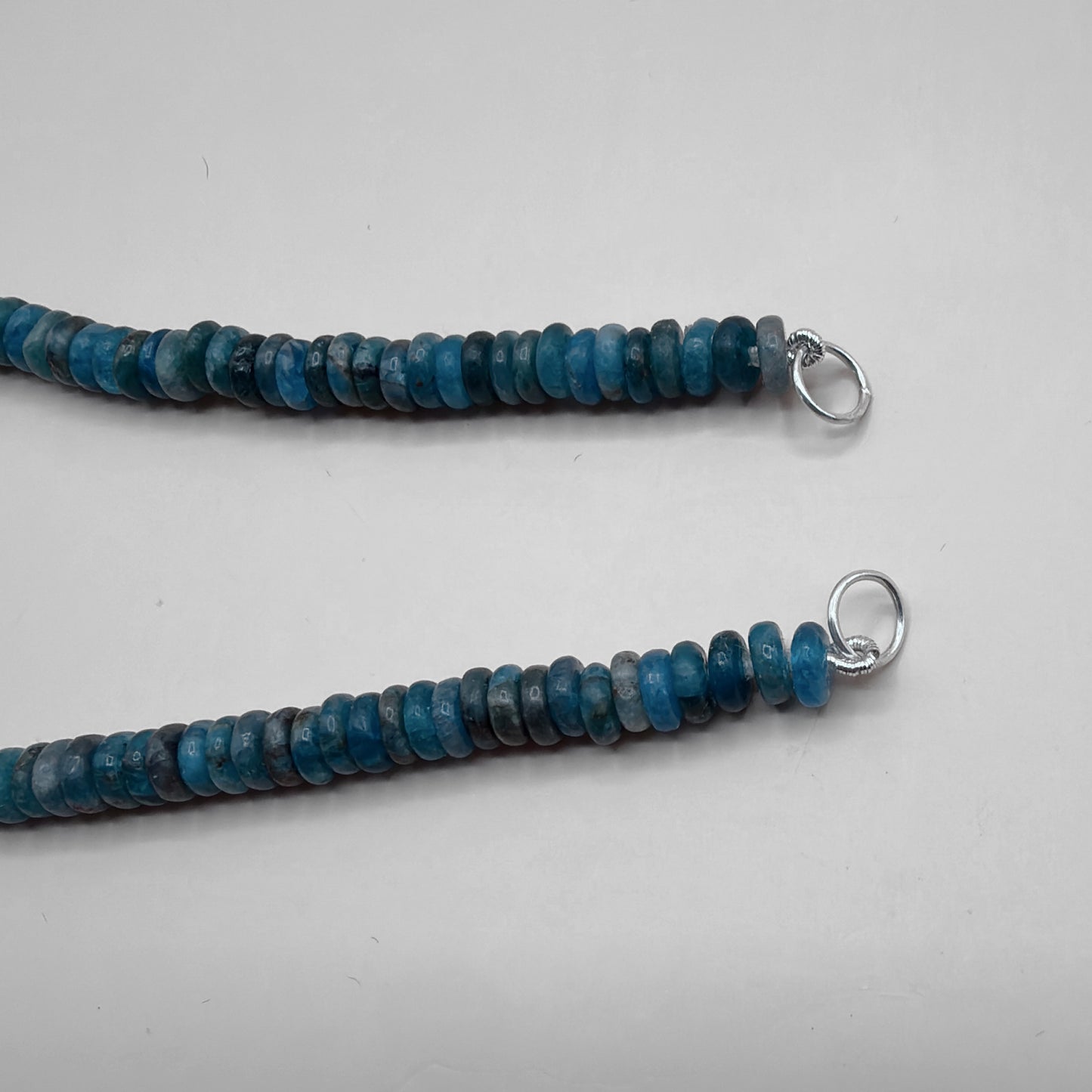 Close-Up of Sterling Silver Jump Rings and French Wire on Blue Apatite Rondelle Necklace